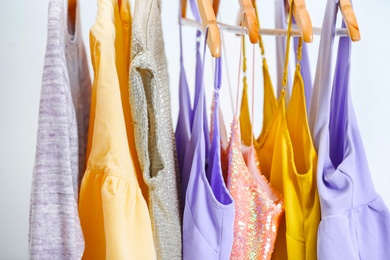 Different clothes on hangers, indoors Photo of Different clothes on hangers, indoors
