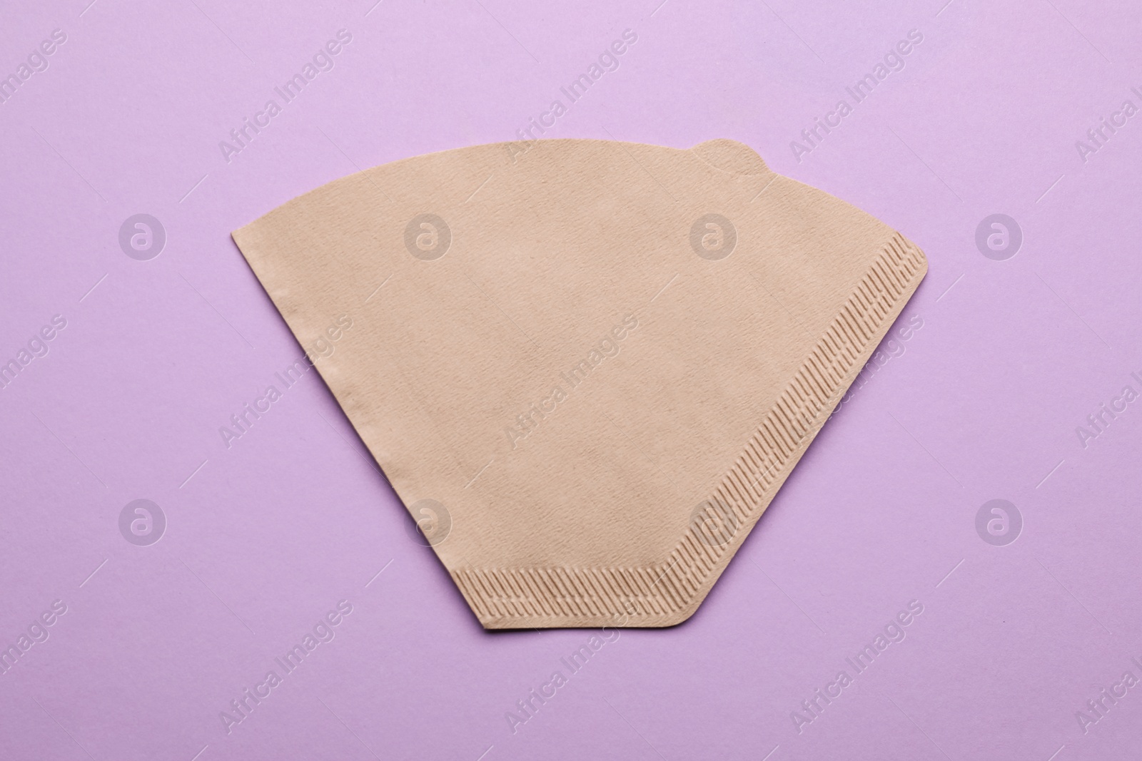 Paper coffee filter on lilac background, top view Photo of Paper coffee filter on lilac background, top view