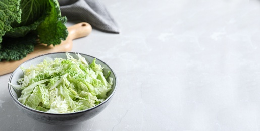 Cut fresh savoy cabbage in bowl on light table, closeup. Space for text Photo of Cut fresh savoy cabbage in bowl on light table, closeup. Space for text