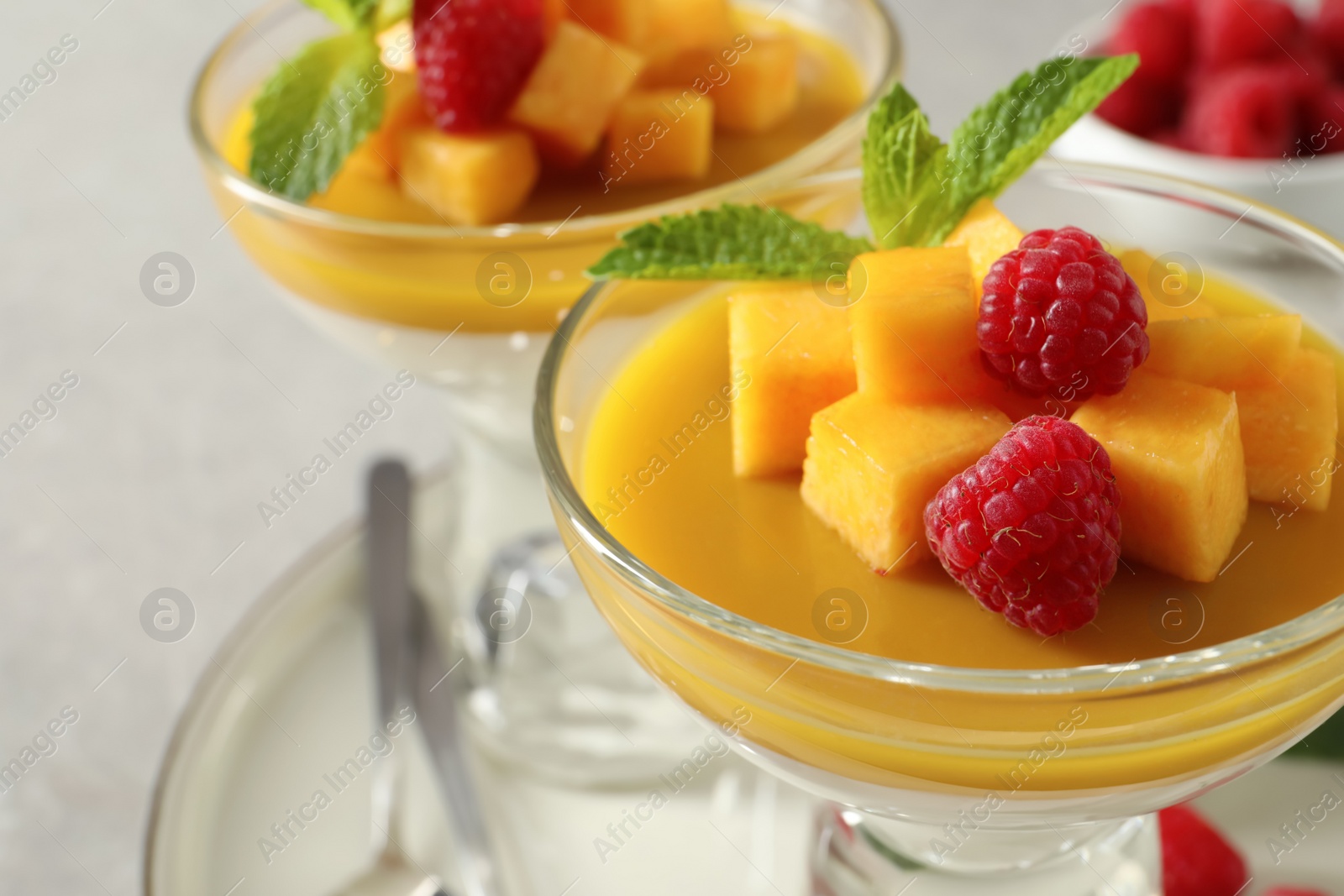 Delicious panna cotta with mango and raspberries, closeup Photo of Delicious panna cotta with mango and raspberries, closeup