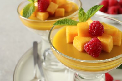 Delicious panna cotta with mango and raspberries, closeup Photo of Delicious panna cotta with mango and raspberries, closeup