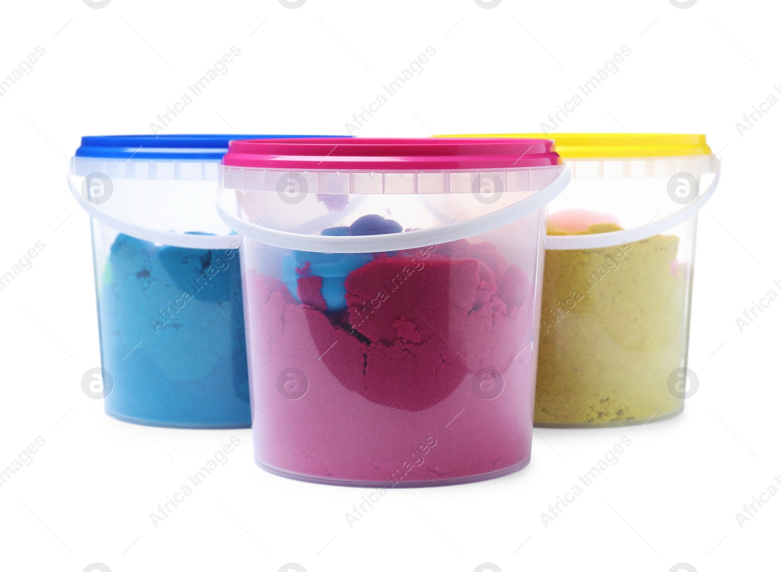 Kinetic sand and toys in buckets on white background Photo of Kinetic sand and toys in buckets on white background