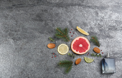 Photo of Flat lay composition with bottle of perfume on grey background, space for text