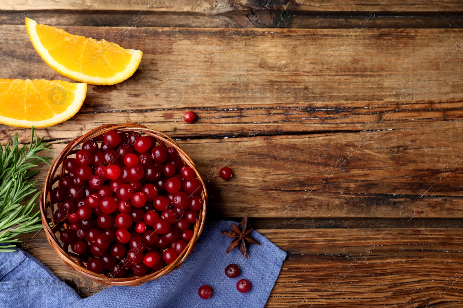 Flat lay composition with fresh ripe cranberries on wooden table. Space for text Photo of Flat lay composition with fresh ripe cranberries on wooden table. Space for text