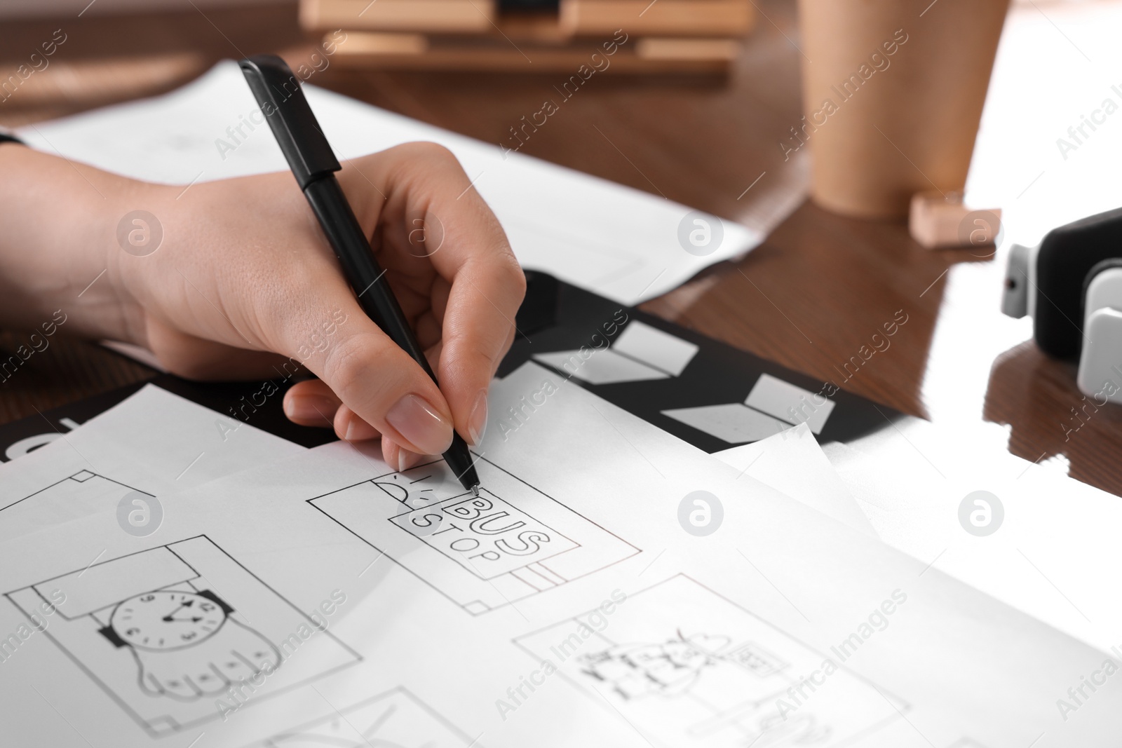 Woman drawing cartoon sketch at workplace, closeup. Pre-production process Photo of Woman drawing cartoon sketch at workplace, closeup. Pre-production process