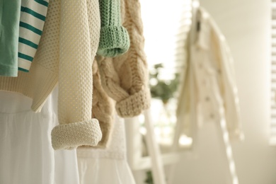 Rack with stylish women's clothes indoors, space for text. Interior design Photo of Rack with stylish women's clothes indoors, space for text. Interior design