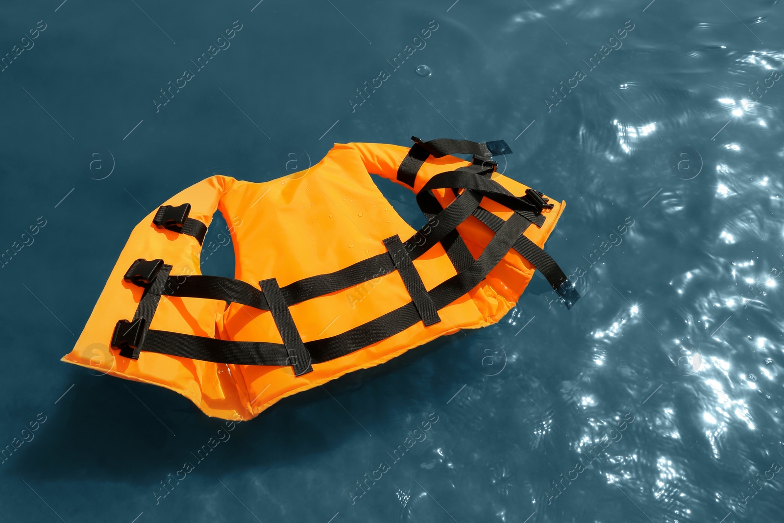 Orange life jacket floating in sea, above view. Emergency rescue equipment Photo of Orange life jacket floating in sea, above view. Emergency rescue equipment