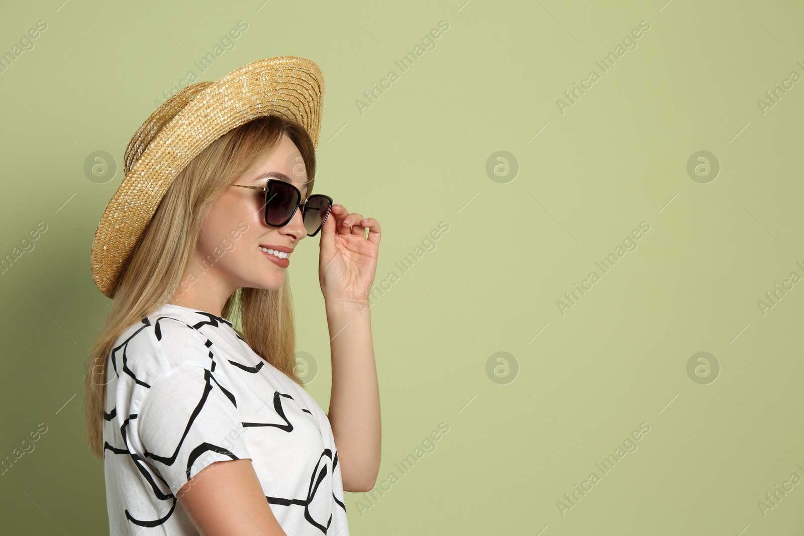Beautiful young woman wearing straw hat and sunglasses on light green background, space for text. Stylish headdress Photo of Beautiful young woman wearing straw hat and sunglasses on light green background, space for text. Stylish headdress