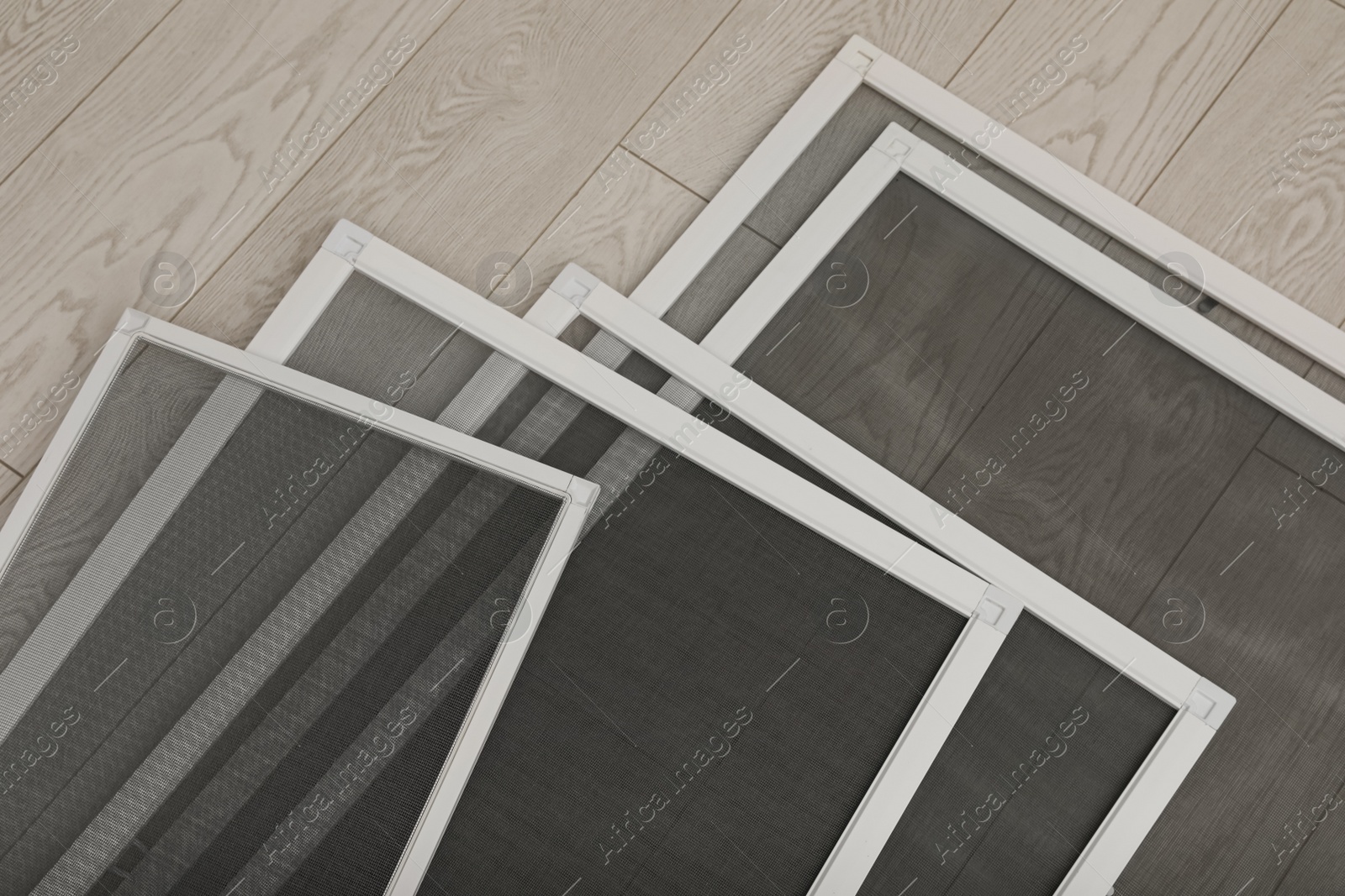 Set of window screens on wooden floor, closeup Photo of Set of window screens on wooden floor, closeup