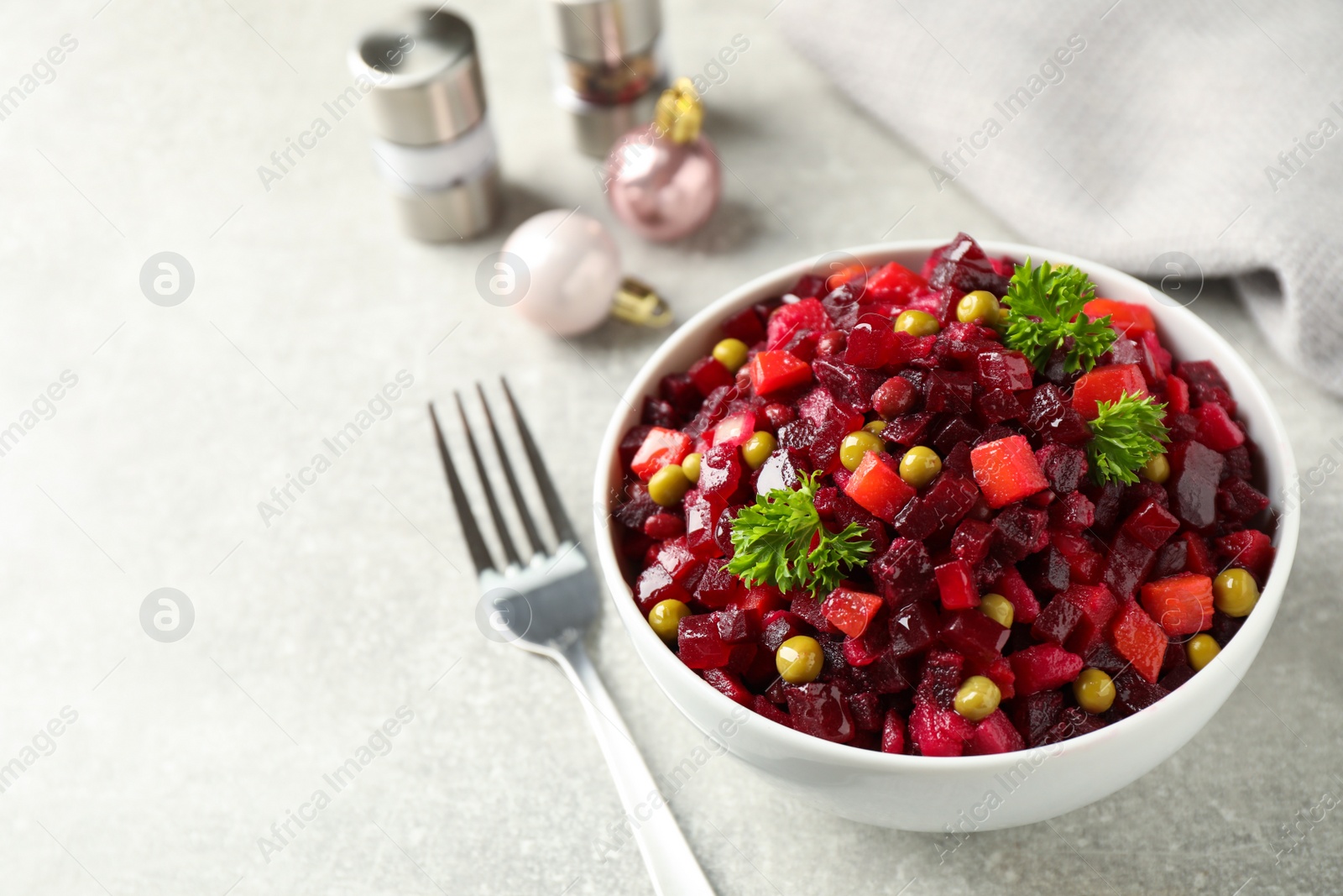 Traditional Russian salad vinaigrette served on light table. Space for text Photo of Traditional Russian salad vinaigrette served on light table. Space for text