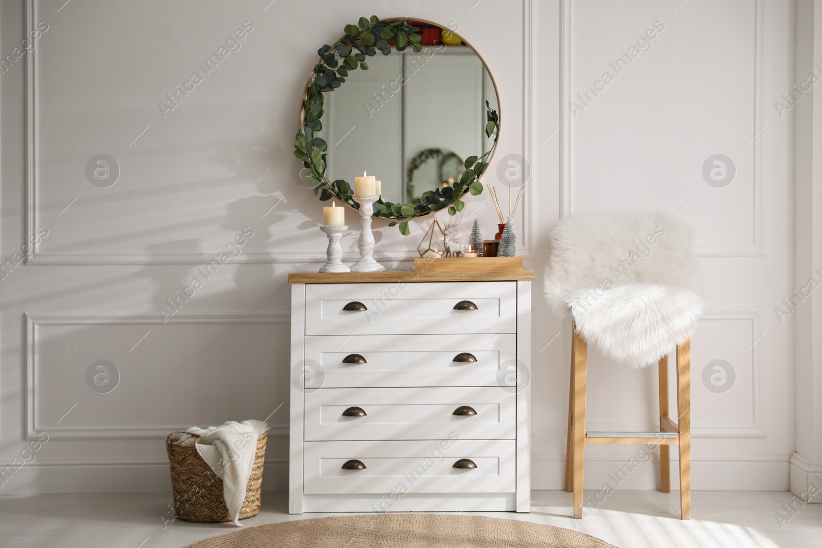 Modern room interior with chest of drawers and mirror on white wall Photo of Modern room interior with chest of drawers and mirror on white wall