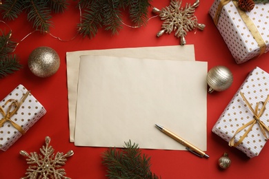 Flat lay composition with blank sheets of paper on red background, space for text. Writing letter to Santa Photo of Flat lay composition with blank sheets of paper on red background, space for text. Writing letter to Santa