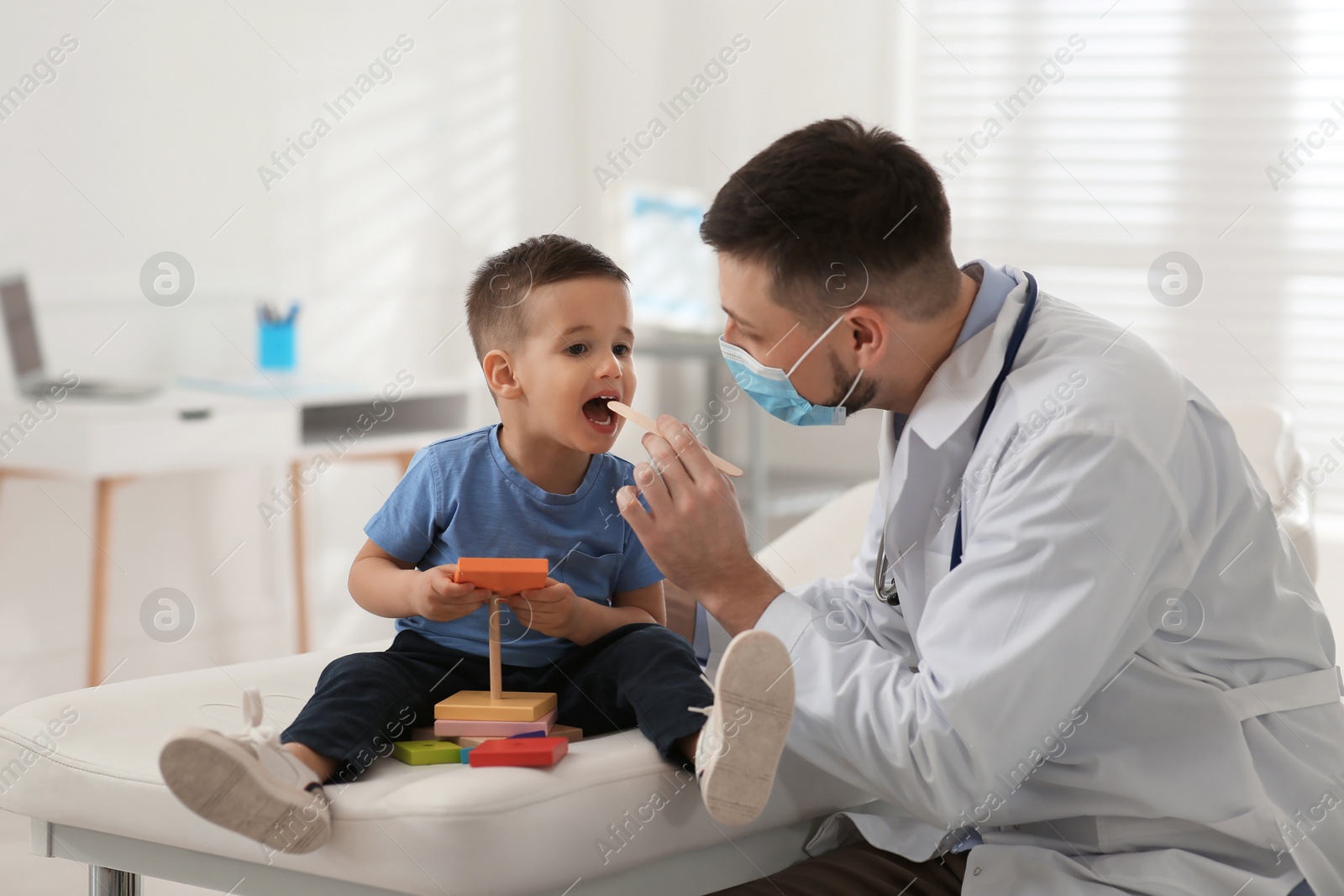 Pediatrician examining cute little boy at hospital Photo of Pediatrician examining cute little boy at hospital