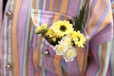 Woman wearing shirt with flowers in pocket, closeup Photo of Woman wearing shirt with flowers in pocket, closeup