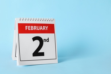 Calendar with date February 2nd on light blue background, space for text. Groundhog day Photo of Calendar with date February 2nd on light blue background, space for text. Groundhog day
