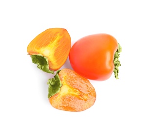 Delicious cut and whole fresh persimmons isolated on white, top view Photo of Delicious cut and whole fresh persimmons isolated on white, top view