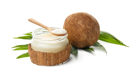 Jar with coconut oil and nut on white background Photo of Jar with coconut oil and nut on white background