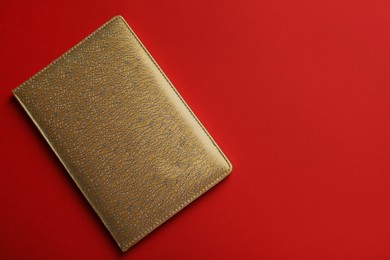 New stylish planner with leather cover on red background, top view. Space for text Photo of New stylish planner with leather cover on red background, top view. Space for text
