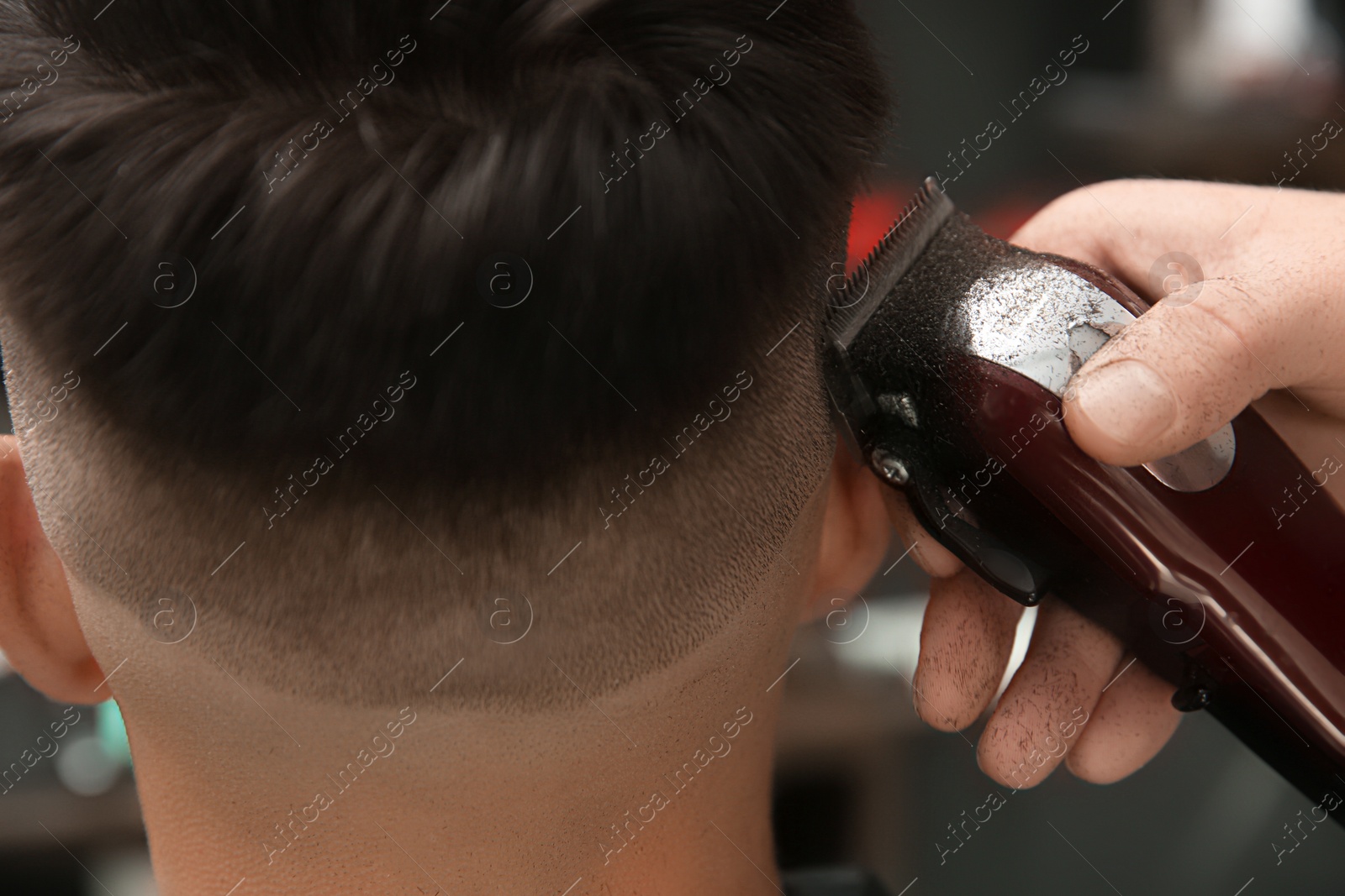 Professional barber making stylish haircut in salon, closeup Photo of Professional barber making stylish haircut in salon, closeup
