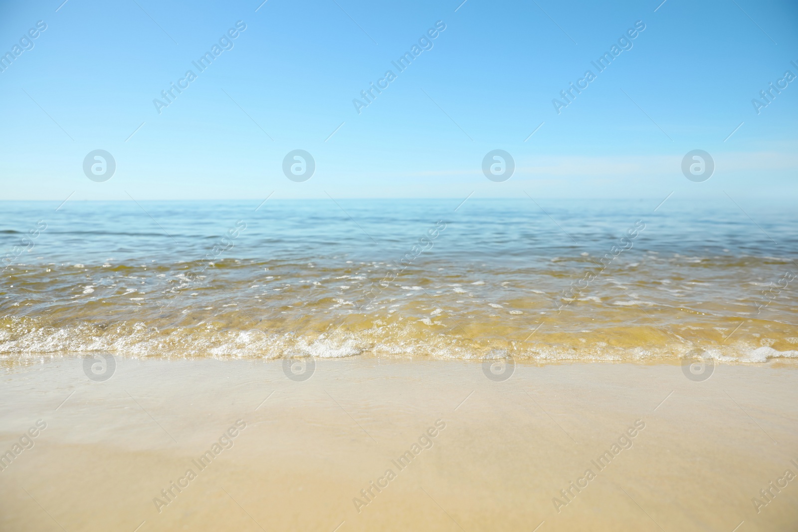 Sea wave rolling on sandy beach in summer, closeup Photo of Sea wave rolling on sandy beach in summer, closeup