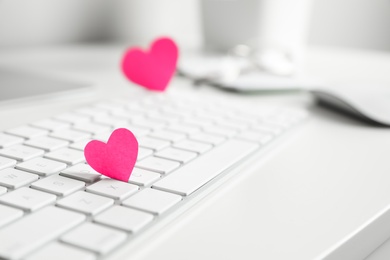 Keyboard with pink hearts on white table, closeup. Valentine's day celebration Photo of Keyboard with pink hearts on white table, closeup. Valentine's day celebration