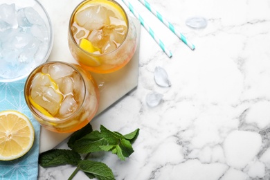 Delicious iced tea on white marble table, flat lay. Space for text Photo of Delicious iced tea on white marble table, flat lay. Space for text