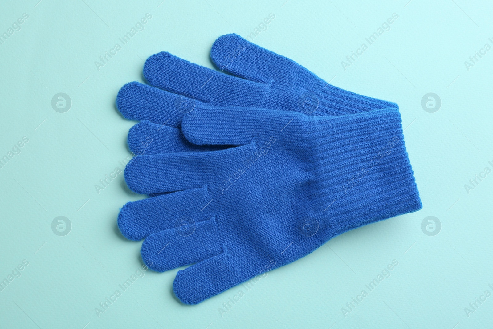 Pair of stylish woolen gloves on light blue background, flat lay Photo of Pair of stylish woolen gloves on light blue background, flat lay