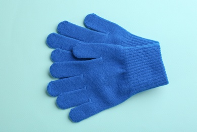 Pair of stylish woolen gloves on light blue background, flat lay Photo of Pair of stylish woolen gloves on light blue background, flat lay