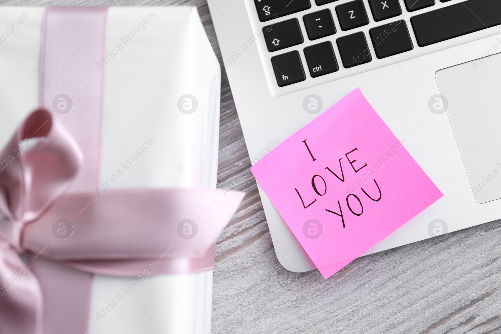 Memory sticker with phrase I Love You on laptop at table, flat lay. Valentine's Day celebration Photo of Memory sticker with phrase I Love You on laptop at table, flat lay. Valentine's Day celebration
