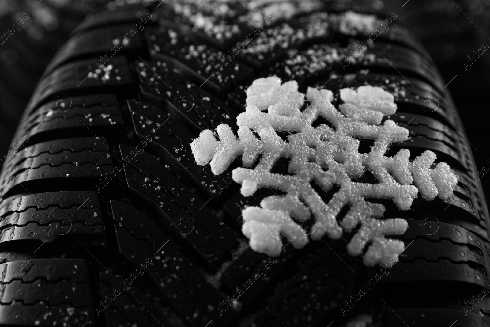Snowy new winter tires as background, closeup Photo of Snowy new winter tires as background, closeup