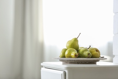 Fresh ripe pears on white table in room. Space for text Photo of Fresh ripe pears on white table in room. Space for text