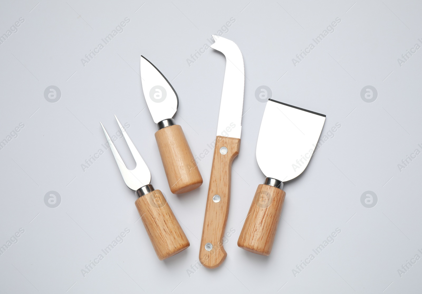 Cheese knives and fork on white background, top view Photo of Cheese knives and fork on white background, top view