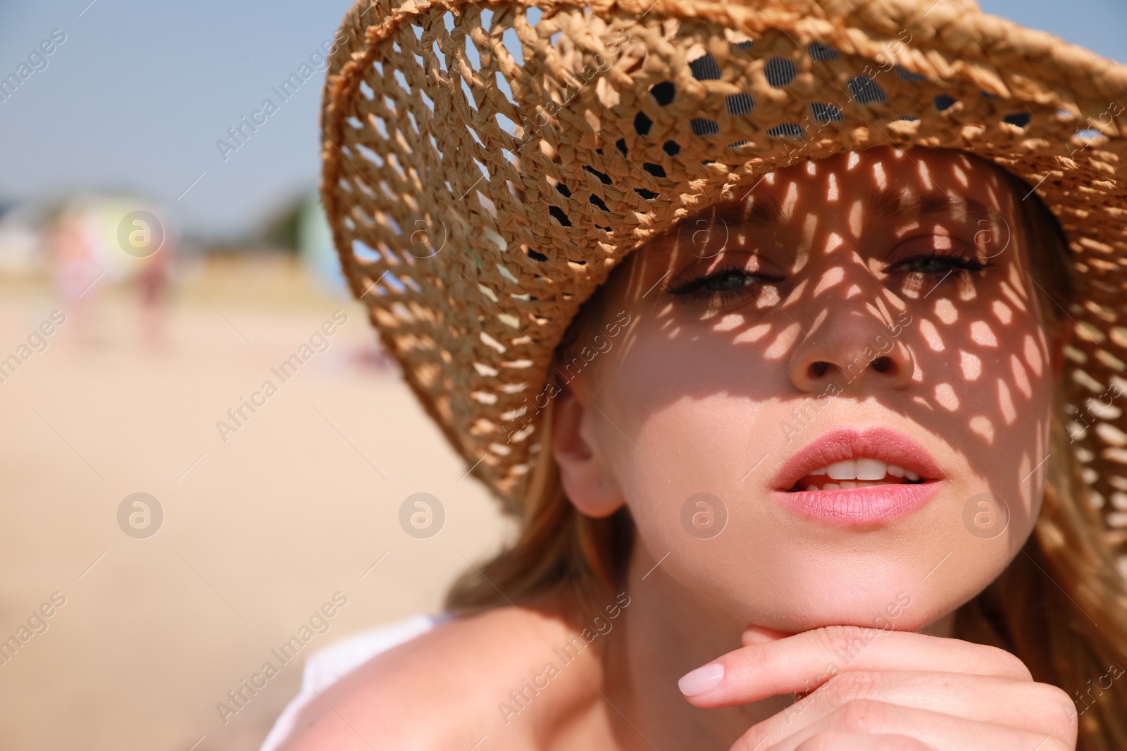 Beautiful woman with straw hat outdoors on sunny day, space for text Photo of Beautiful woman with straw hat outdoors on sunny day, space for text