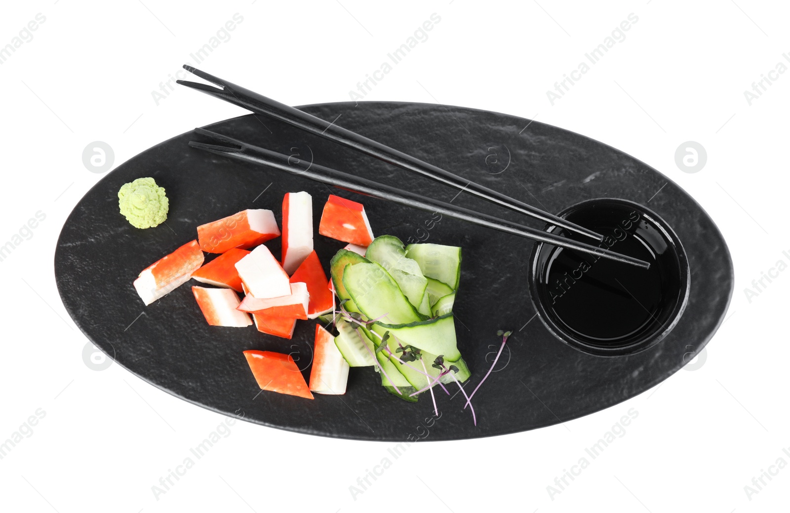Fresh crab sticks with cucumber and soy sauce on white background, flat lay Photo of Fresh crab sticks with cucumber and soy sauce on white background, flat lay