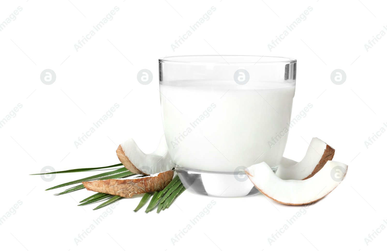 Glass of coconut milk and nuts on white background Photo of Glass of coconut milk and nuts on white background