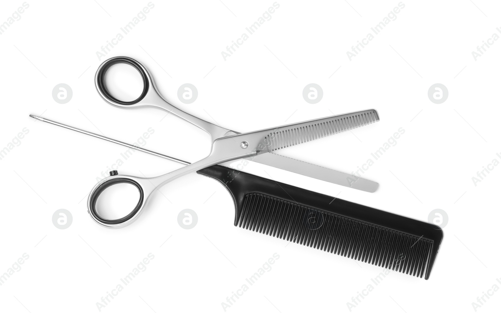 Professional hairdresser thinning scissors and black comb isolated on white, top view. Haircut tools Photo of Professional hairdresser thinning scissors and black comb isolated on white, top view. Haircut tools
