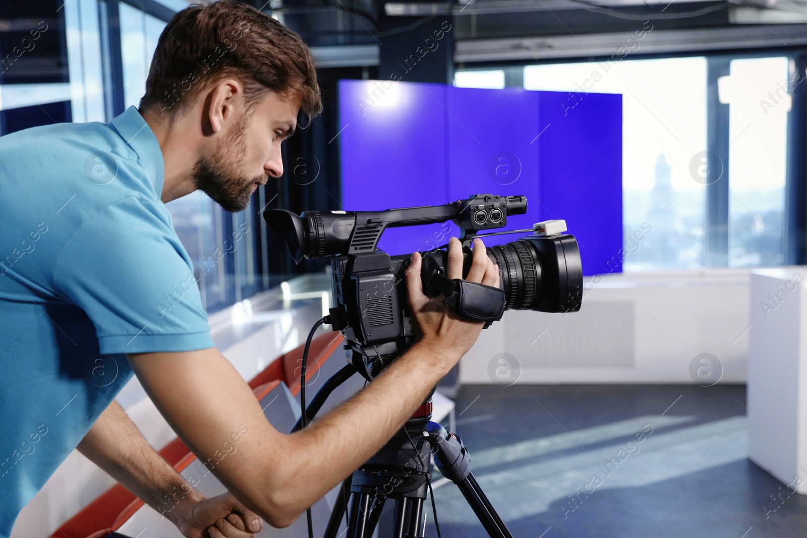 Professional video camera operator working in studio Photo of Professional video camera operator working in studio