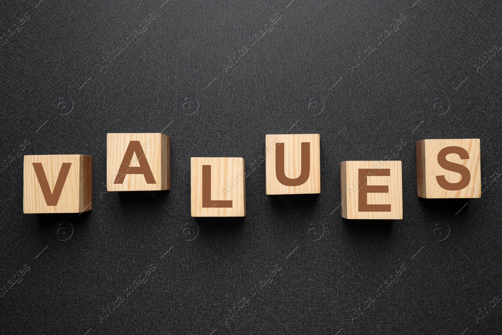 Wooden cubes with word VALUES on black background, flat lay Photo of Wooden cubes with word VALUES on black background, flat lay