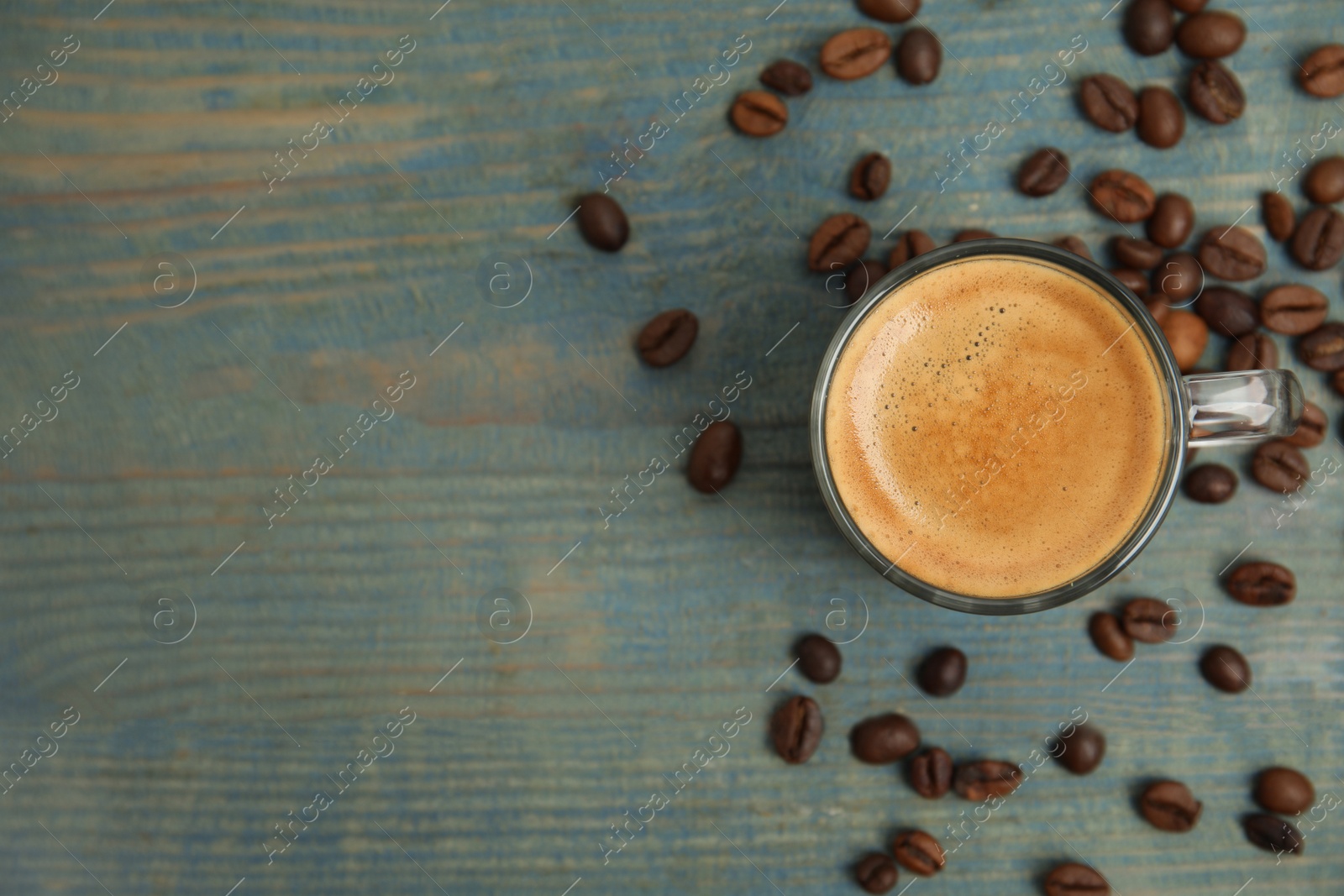 Cup of tasty coffee on blue wooden table, flat lay. Space for text Photo of Cup of tasty coffee on blue wooden table, flat lay. Space for text
