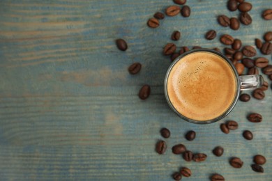 Cup of tasty coffee on blue wooden table, flat lay. Space for text Photo of Cup of tasty coffee on blue wooden table, flat lay. Space for text