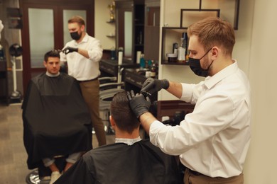 Professional hairdresser making stylish haircut in salon Photo of Professional hairdresser making stylish haircut in salon