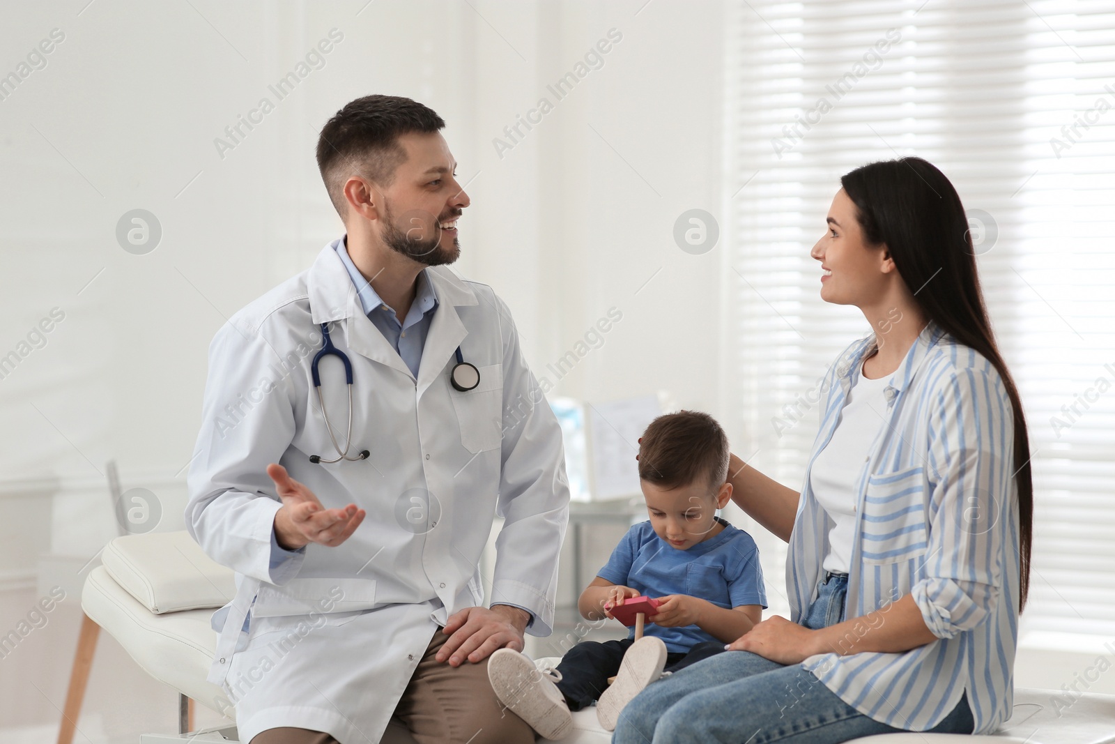 Photo of Mother and son visiting pediatrician in hospital