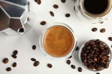 Tasty coffee and beans on white wooden table, flat lay Photo of Tasty coffee and beans on white wooden table, flat lay
