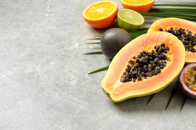 Fresh ripe papaya and other fruits on light grey table. Space for text Photo of Fresh ripe papaya and other fruits on light grey table. Space for text
