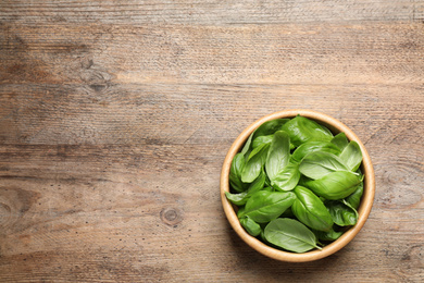 Fresh basil on wooden table, top view. Space for text Photo of Fresh basil on wooden table, top view. Space for text