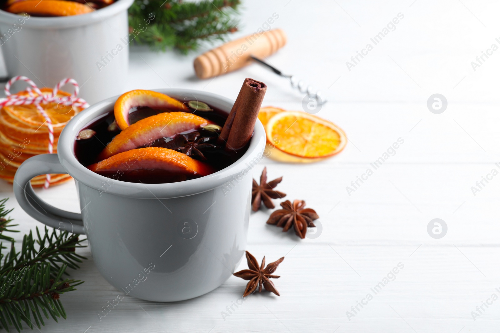 Aromatic mulled wine and ingredients on white wooden table. Space for text Photo of Aromatic mulled wine and ingredients on white wooden table. Space for text