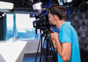 Professional video camera operator working in studio Photo of Professional video camera operator working in studio