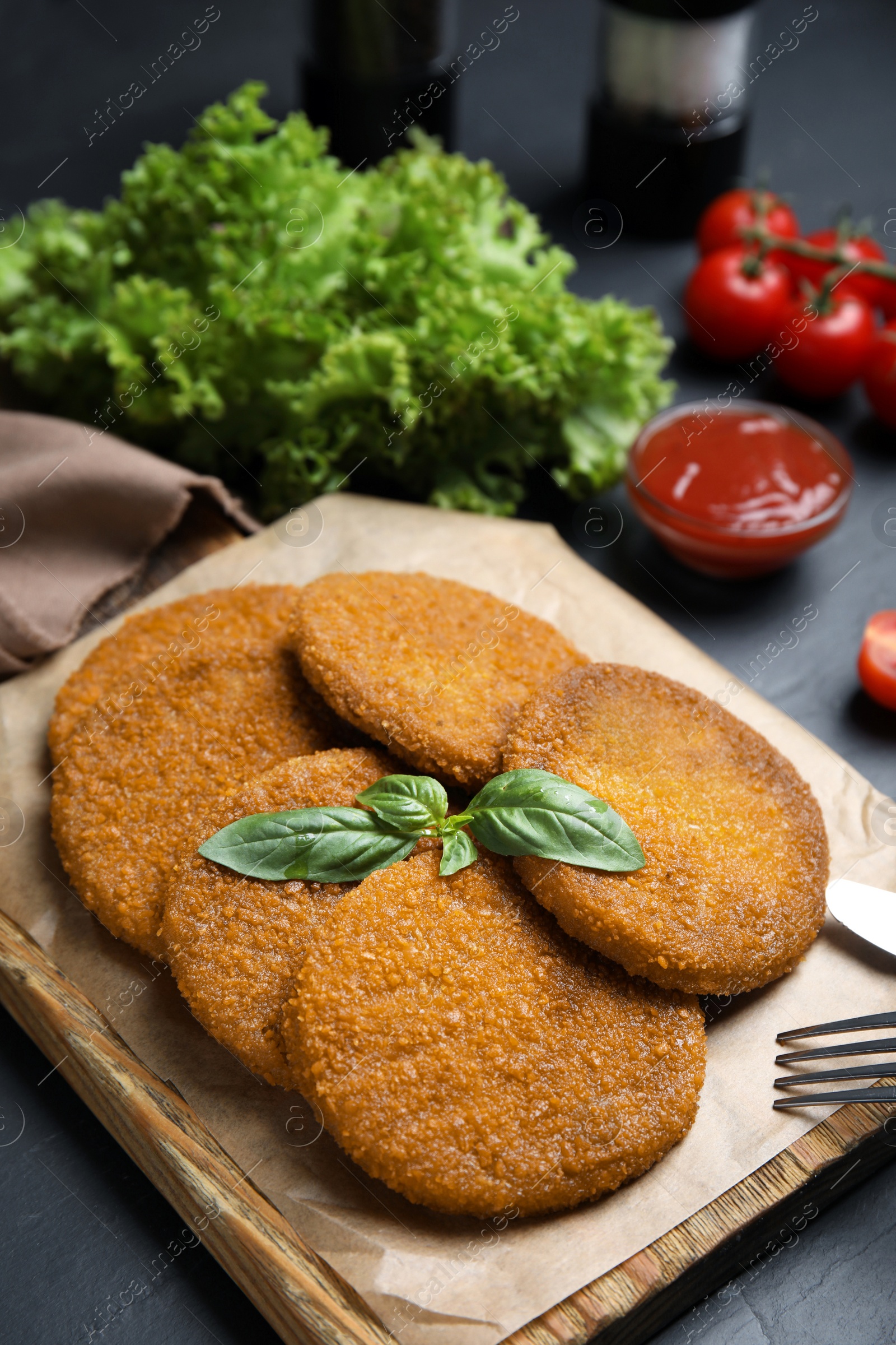 Delicious fried breaded cutlets served on black table, closeup Photo of Delicious fried breaded cutlets served on black table, closeup