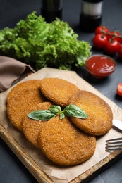 Delicious fried breaded cutlets served on black table, closeup Photo of Delicious fried breaded cutlets served on black table, closeup