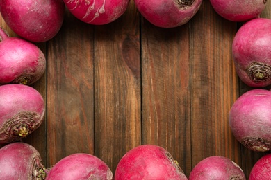Frame made with red turnips on wooden table, flat lay. Space for text Photo of Frame made with red turnips on wooden table, flat lay. Space for text